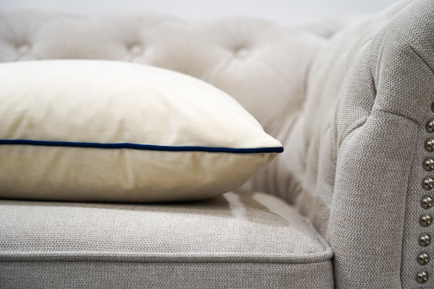 Eggshell Cushion with Navy Piping